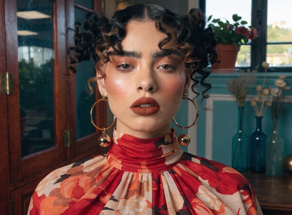 A model showcasing rich terracotta lips and warm eye makeup.